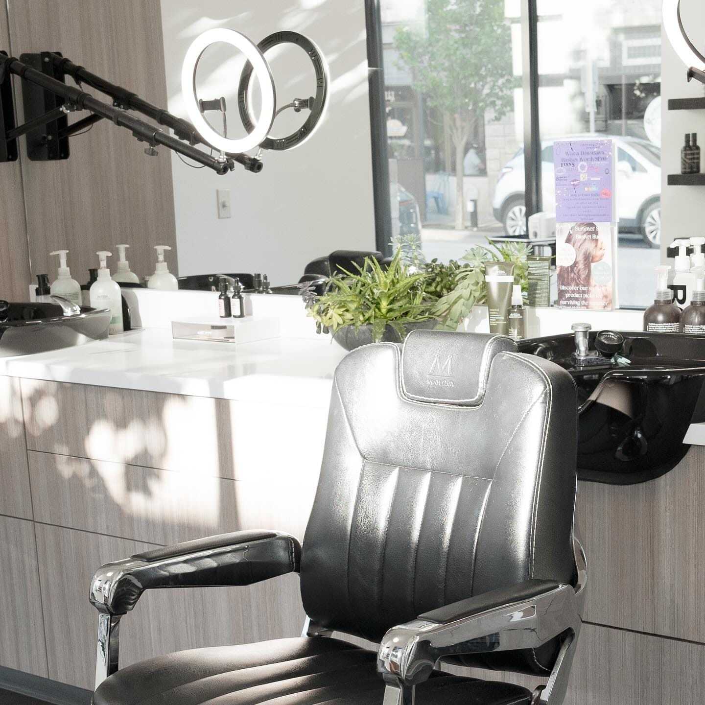 Barber chair in a modern salon with a mirror and hair products in the background.